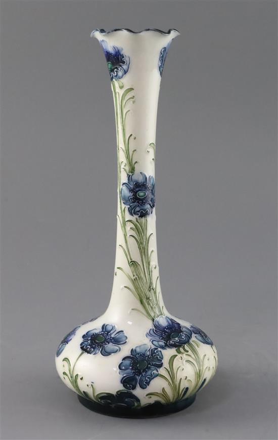 A Moorcroft Florian ware blue poppy vase, Rd. no. for 1902, H.24.2cm, crack to edge of foot